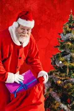 复合图像圣诞老人老人把礼物袋圣诞节树