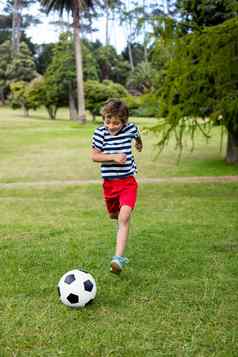 男孩玩足球公园
