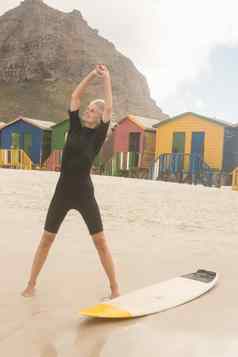 微笑女人伸展运动站冲浪板小屋
