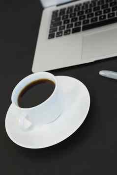 杯咖啡移动PC笔黑色的背景
