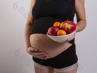 怀孕健康的有机营养怀孕了女人持有新鲜的维生素水果免费的空间的地方文本概念期望健康