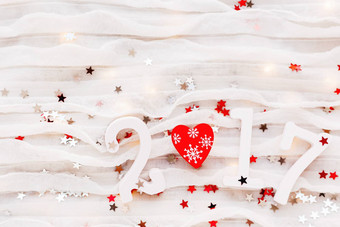 圣诞节一年背景红色的心光灯泡五彩纸屑白色织物