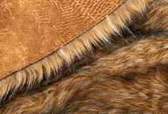 特写镜头毛茸茸的黑暗棕色（的）人造皮毛织物背景纹理