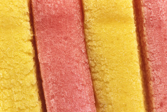 黄色的粉红色的彩色的泡沫口香糖纹理新鲜橡皮糖美味的背景美味的背景宏特写镜头