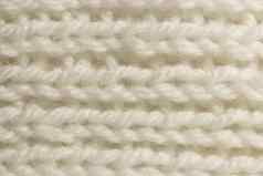 白色羊毛针织纹理水平编织用钩针编织详细的行毛衣纺织背景宏特写镜头