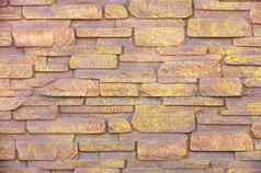 石头墙使自然石头大小覆盖棕色（的）黄金油漆