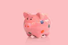 粉红色的陶瓷小猪银行粉红色的背景储蓄钱概念