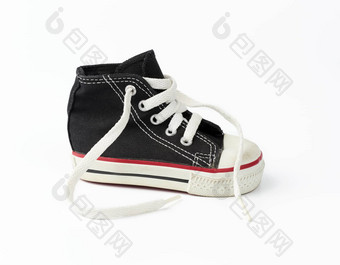 黑色的纺织孩子们的运动鞋白色解开鞋带