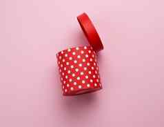 轮红色的纸板盒子白色波尔卡点粉红色的背景