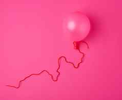 膨胀的粉红色的空气气球粉红色的背景
