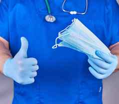医生统一的蓝色的乳胶手套无菌面具