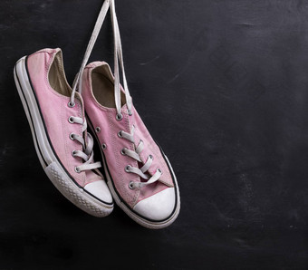 一对粉红色的纺织运动鞋挂花边