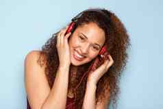 快乐的年轻的女人听音乐耳机