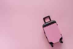 迷你小指行李玩具模型粉红色的柔和的彩色的背景