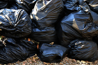 桩浪费塑料袋垃圾垃圾特写镜头背景桩垃圾塑料黑色的污染垃圾塑料浪费袋背景