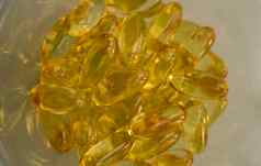 极端的关闭鱼石油橙色黄色的-3胶囊鱼石油ωωω维生素维生素维生素背景健康的维生素产品概念