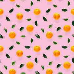 普通话无缝的模式橘子克莱门泰孤立的粉红色的背景绿色叶子集合细无缝的模式