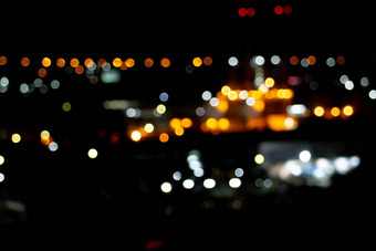 光晚上城市散景摘要背景闪闪发光的星星散景橙色散景底图片黑色的背景图像