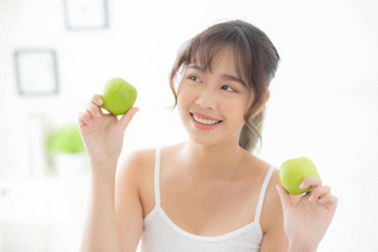 美丽的肖像年轻的亚洲女人持有吃绿色苹果水果卧室<strong>首页</strong>生活方式营养女孩<strong>健康</strong>的护理重量损失<strong>健康健康</strong>概念