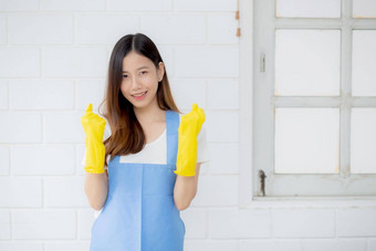 肖像年轻的亚洲女人管家橡胶手套围裙保护首页统一的女仆清洁洗女孩站工人积极的人生活方式概念