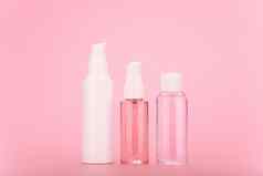 脸奶油清洁泡沫过来这里乳液透明的瓶白色帽明亮的粉红色的背景