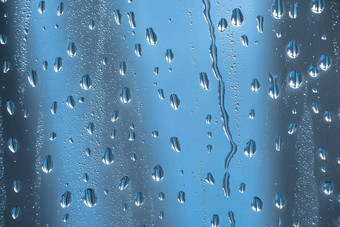 摘要背景点缀水滴雨滴玻璃多雨的天气闪闪发光的闪亮的表面水玻璃水滴形式球球体蓝色的雨滴
