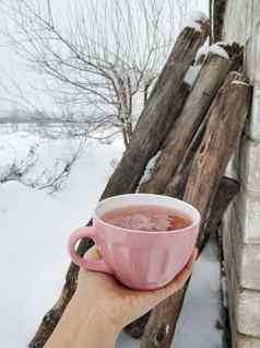 粉红色的杯子热树莓茶背景雪冬天场茶小时变暖冷冬天