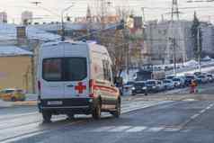 白色救护车小型公共汽车冬天湿街车道
