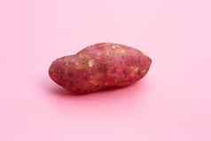 甜蜜的土豆粉红色的背景
