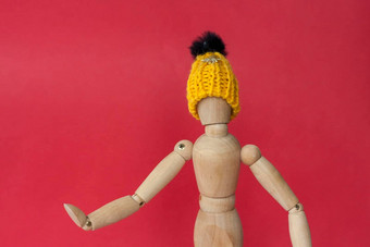 木人体模型男人。针织黄色的他点的地方人体模型男人。使木红色的背景