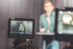 年轻的记者电视记录工作室会说话的麦克风模糊的电影相机