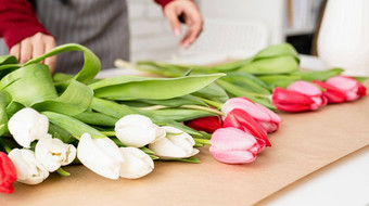 女人花店使花束新鲜的色彩斑斓的郁金香
