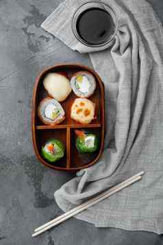 日本bento午餐盒子筷子灰色的石头背景前视图平躺