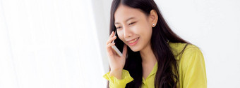 年轻的亚洲业务女人工作形式<strong>首页</strong>办公室调用电话成功<strong>首页</strong>女商人移动PC电脑桌子上女会说话的智能<strong>手机</strong>工作场所沟通概念