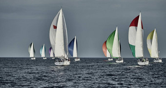 帆船竞争帆赛船会日落比赛帆船反射帆水五彩缤纷的大三角帆数量船船尾船