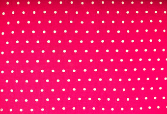 粉红色的波尔卡点织物波尔卡点光粉红色的背景