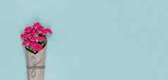 花束小用花装饰的粉红色的玫瑰包装工艺纸蓝色的背景复制空间