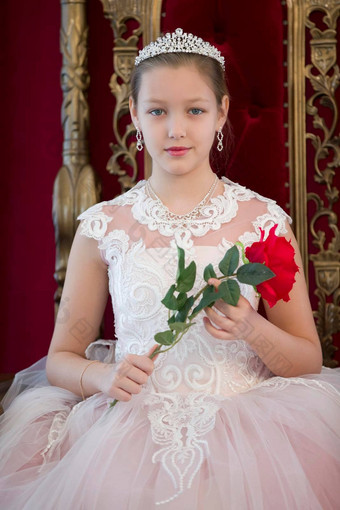 少年女孩聪明的红色的奢侈品皇家扶手椅女孩公主女王红色的椅子豪华的年轻的夫人朱红色玫瑰白色衣服红色的扶手椅
