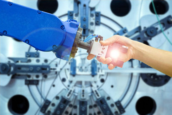 工业机器人握手人类的关系工作工业制造业概念工业耀斑过滤器模糊机械工作蓝色的语气背景