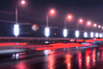 模糊的灯移动汽车灯笼反映湿沥青晚上城市