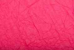 粉红色的皱巴巴的纸纹理背景