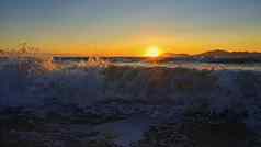 美丽的日落海波自然色彩斑斓的背景概念夏天海假期希腊岛食物