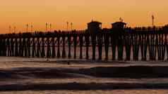 码头轮廓日落加州美国海滨冲浪度假胜地海洋热带海滩冲浪者等待波
