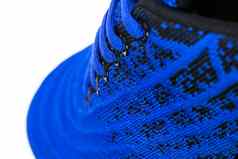 部分蓝色的运动鞋使织物鞋带片段体育鞋子