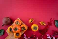 前视图新鲜的甜蜜的柿子叶子红色的表格背景中国人月球一年