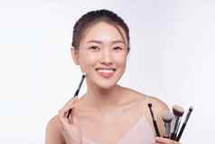 肖像有吸引力的亚洲微笑女人浅黑肤色的女人孤立的白色工作室拍摄刷化妆
