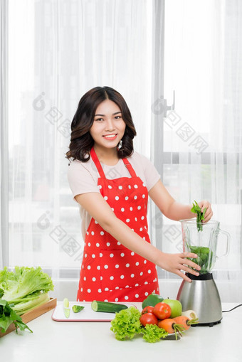 健康的吃烹饪素食者食物节食人概念关闭年轻的女人搅拌机绿色蔬菜使排毒摇奶昔<strong>首页</strong>