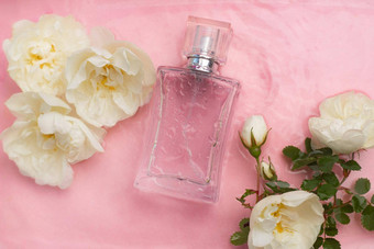 香水瓶花背景水滴瓶香水碑文气味香水粉红色的背景水滴复制空间