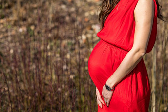 美丽的怀孕了女人感觉快乐自然采取护理孩子年轻的期待妈妈。持有婴儿怀孕了肚子孕妇产前护理女人怀孕概念