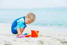 男孩玩海滩玩具热带海滩